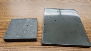 Two sections of sintered basalt blocks made with varying grain size distribution. The slab on the left was polished.