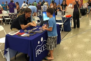 Chris Yoakum, PISCES PIO, plays space trivia with a young student during the debut AstroDay West Hawaii event on Nov. 4.