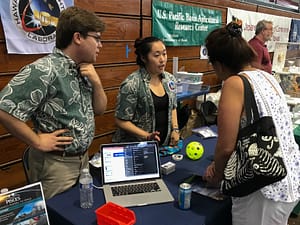 Amber Imai-Hong of Hawaii Spaceflight Lab talks with a visitor about their work in satellite development. 