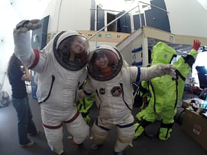 Schelin Ireland (left) and Marianna Oka (right—a student of Kamehameha Schools’ Kapalama campus), got suited up for a space walk outside the HI-SEAS habitat on Mauna Loa during the 2015 PISCES STARS Program.