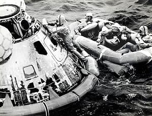 The Navy helping astronauts Michael Collins, Neil Armstrong, and Buzz Aldrin out of the re-entry capsule and into a raft (photo courtesy Milt Putnam). The Navy aircraft carrier USS Hornet then transported the Apollo crew and capsule to Pearl Harbor, before they headed back to Texas.