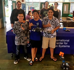 (Foreground) Robotics Club members and (background, L-R) PISCES Director Rodrigo Romo with club mentors Joel Paye and Tayeh Madjeska.
