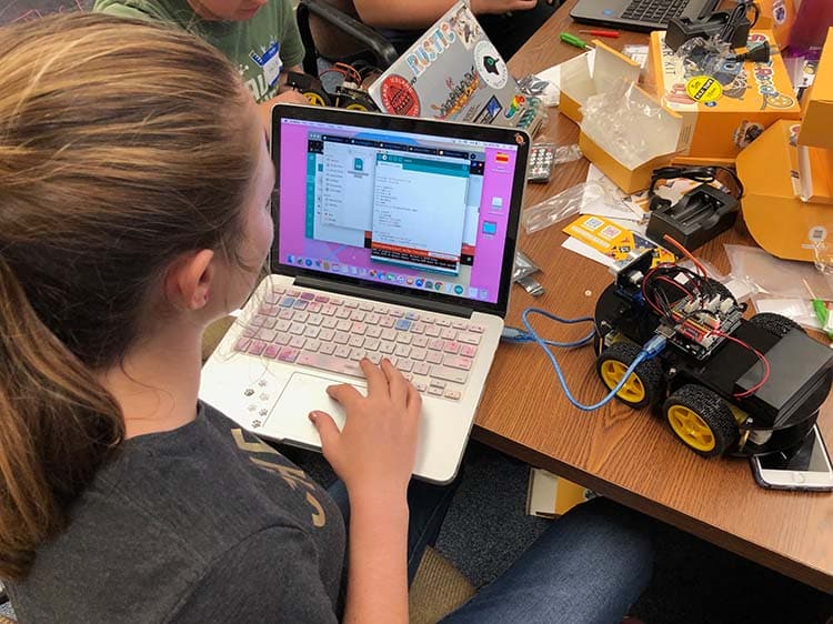 student programming a robot