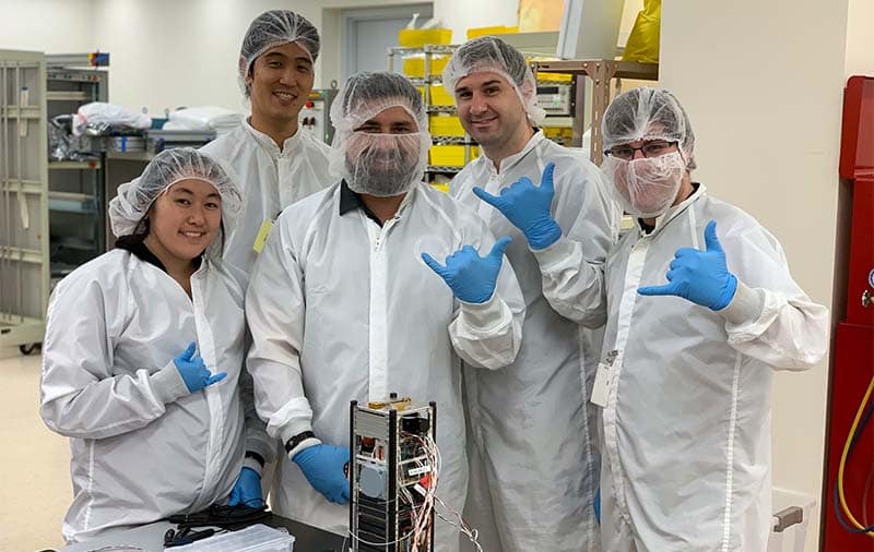 Hawaii Space Flight Lab students pose with their cube satellite.