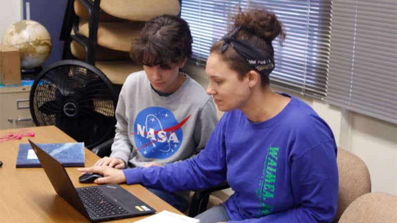 two students on a laptop computer together